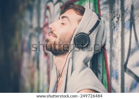 young hipster gay man listening music headphones