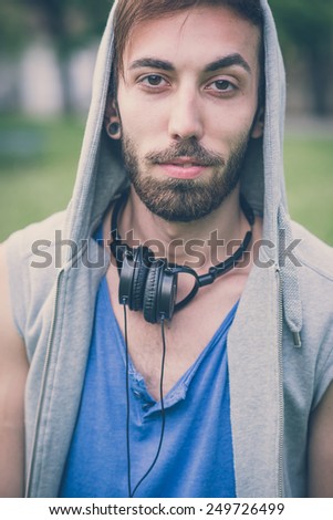 young hipster gay man listening music headphones