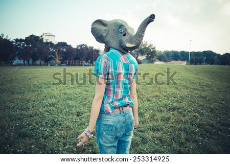 elephant mask beautiful young hipster woman in the city