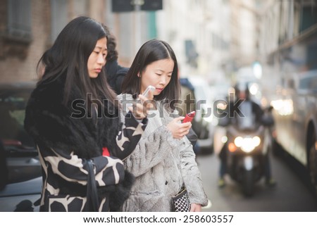 MILAN, ITALY - MARCH 01: People during Milan Fashion week, Italy on March, 01 2015. Eccentric and fashionable people outside city during Milan fashion week wait for models and famous people