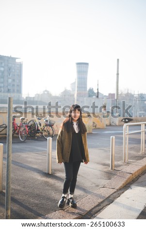 young beautiful asian hipster woman in the city - walking the street crosswalk having fun