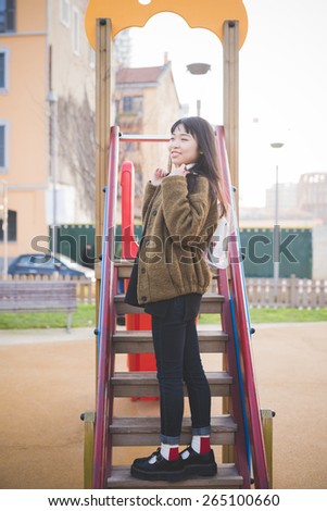 young beautiful asian hipster woman in the city
