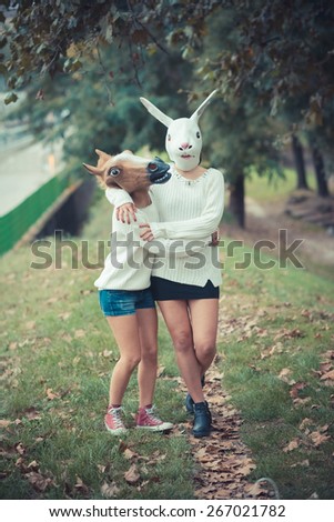 horse and rabbit mask young couple beautiful women girls autumn outdoor