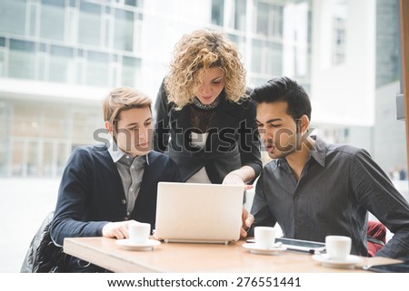 Multiracial business people working connected with technological devices at the bar