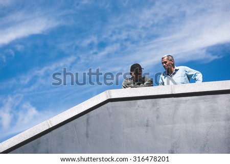 BUDAPEST - SEPTEMBER 7 : War syrian refugees at the Keleti Palyaudvar Railway Station on 1 September 2015 in Budapest, Hungary. Hungarian people looking down to the refugees camping from a staircase