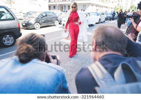 MILAN, ITALY - SEPTEMBER 25: People during Milan Fashion week, Italy on SEPTEMBER 25, 2015. Eccentric and fashionable woman posing for fans and photographer outside city during Milan fashion week