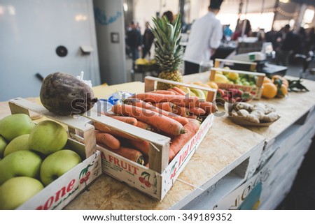 MILAN, ITALY - NOVEMBER 7: People visiting Eat Market, a street food parade with international dishes  in Milan on November, 7 2015. Close up on different type of veggie and fruit on a box