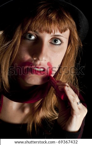 girl turns her face with lipstick on black background