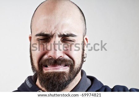bearded man who cries on white background