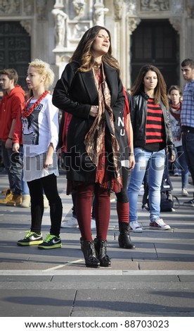MILAN, ITALY- NOVEMBER 10: Laura Pausini sings in Piazza Duomo in Milan November 10, 2011. Laura Pausini, famous italian singer, presents her last album \'INEDITO\' by flash mob in Milan Piazza Duomo