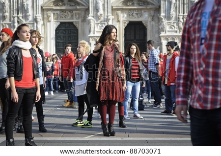 MILAN, ITALY- NOVEMBER 10: Laura Pausini sings in Piazza Duomo in Milan November 10, 2011. Laura Pausini, famous italian singer, presents her last album \'INEDITO\' by flash mob in Milan Piazza Duomo
