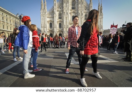 MILAN, ITALY- NOVEMBER 10: Laura Pausini sings in Piazza Duomo in Milan November 10, 2011. Laura Pausini, famous italian singer, presents her last album 'INEDITO' by flash mob in Milan Piazza Duomo