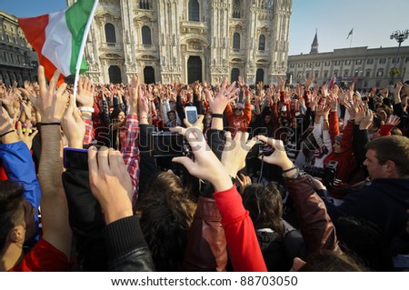 MILAN, ITALY- NOVEMBER 10: Laura Pausini sings in Piazza Duomo in Milan November 10, 2011. Laura Pausini, famous italian singer, presents her last album 'INEDITO' by flash mob in Milan Piazza Duomo