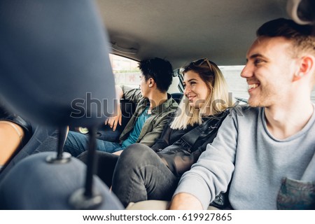 Group of friends multiethnic millennials view from automobile window traveling by car - togetherness, interaction, car sharing concept