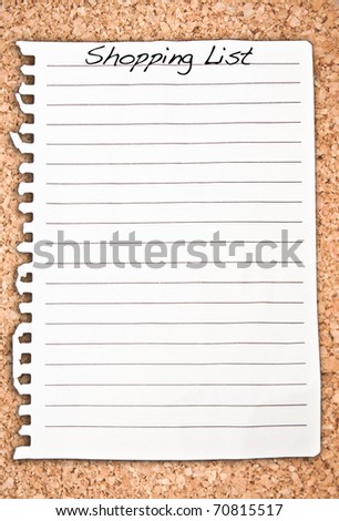 Vertical shopping list on cork background