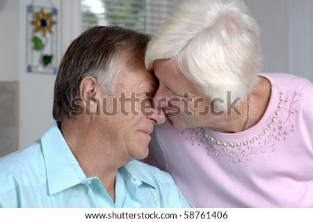 Senior romantic couple shares some intimate moments at their home.