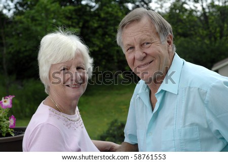 Senior romantic couple shares some intimate moments in their garden.
