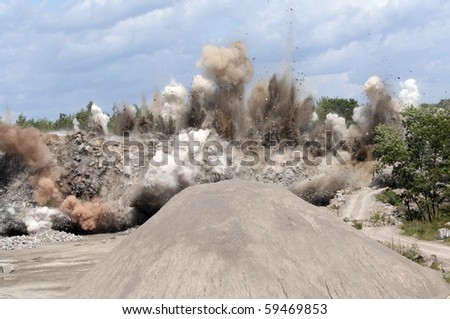 Miners set an explosion at the open pit quarry.