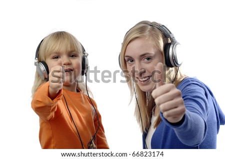 Teenage girl and toddler use headsets to listen music.