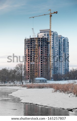 Unfinished building on the river bank in winter