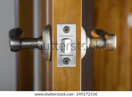 Opened wooden door with latch handle closeup