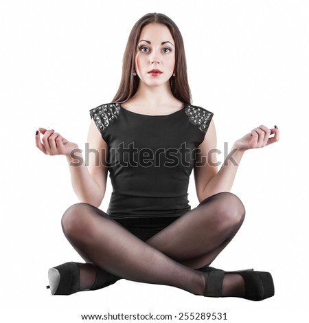 Young female yoga sitting in a cross-legged posture and meditating, isolated on white background