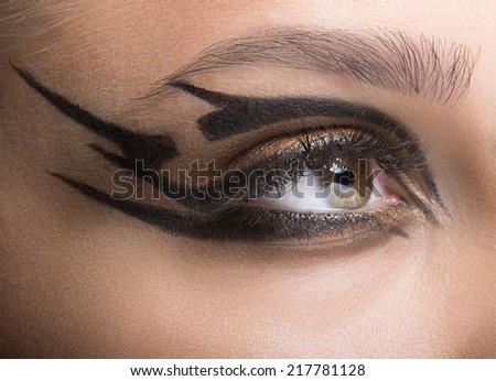 Closeup shot of woman eye with futuristic makeup