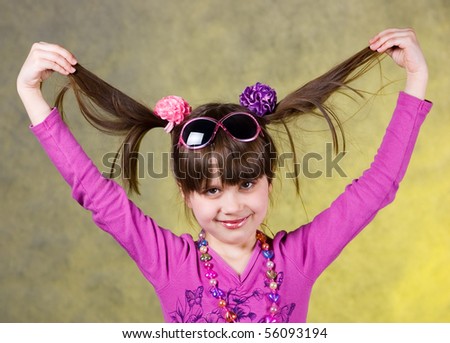 Portrait of young happy girl with tails of hair