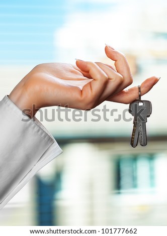 Accounting.Woman\'s hand with the keys to the apartment