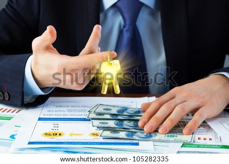Accounting.businessman holding the key to success.
