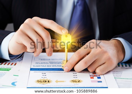 Accounting. businessman holding the key to success.