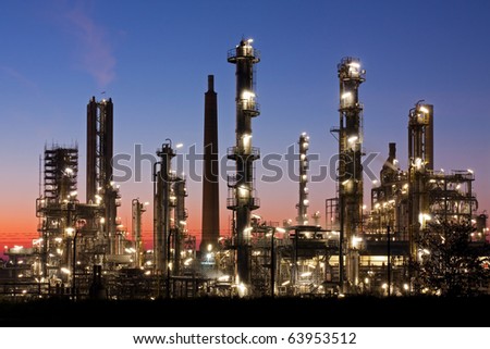 Oil refinery in Schleswig-Holstein, Germany just after sunset, petrochemical industry night scene