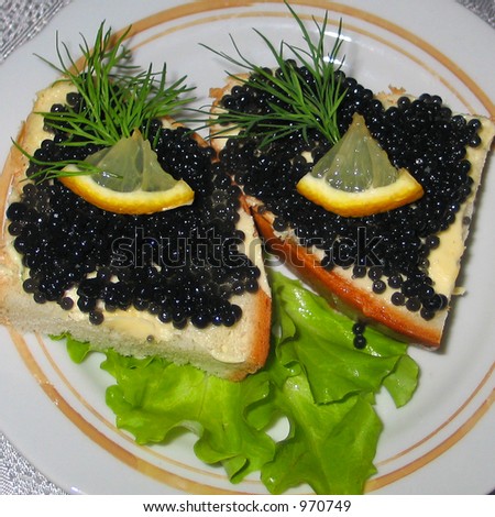 A couple of black osetrova caviar sandwiches which were cooked in an one Russian restaurant.