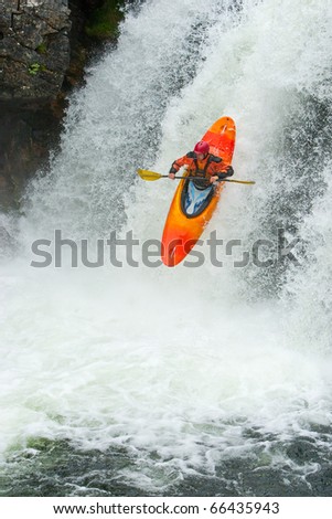 Kayaker jumping from the waterfall