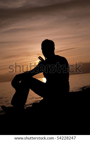 Alone Man drinking on the beach