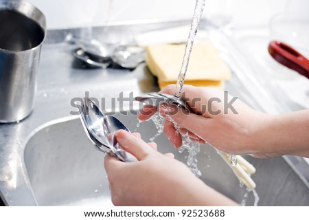 Woman washing spoons
