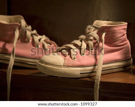 Untied Pink Chuck Taylors High tops on bench