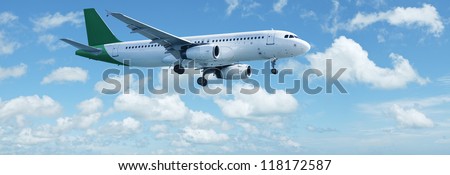 Jet plane in a blue cloudy sky is maneuvering for landing. Panoramic composition.
