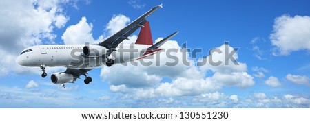 Jet plane in a blue sky. Panoramic composition.