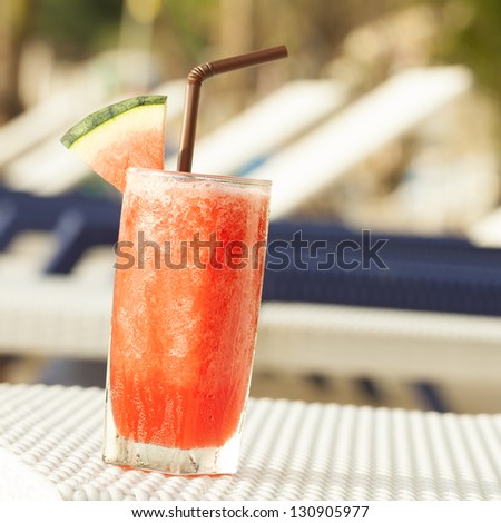 Watermelon shake on the beach chair. Square composition.