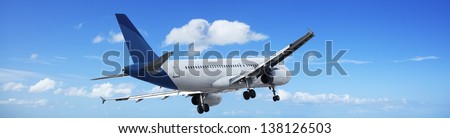 Jet plane in a blue sky. Panoramic composition.