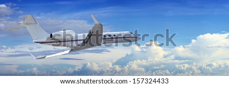 Corporate jet cruising in a cloudy sky