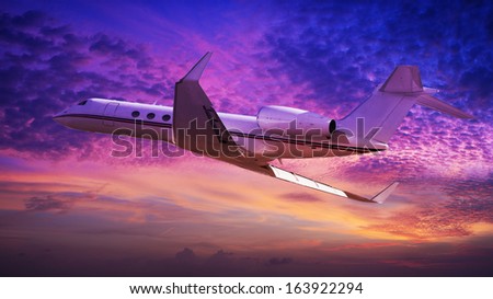 Private jet cruising at sunset