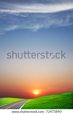 Summer landscape with country road at sunset