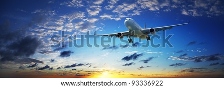 Jet plane in a sunset sky. Panoramic composition in high resolution.