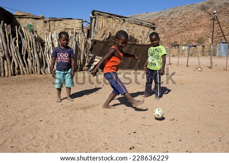 DAMARALAND, NAMIBIA - JUNE 23: Unidentified african boys play football in Damaraland village on 23 of June 2013 in Namibia, South Africa
