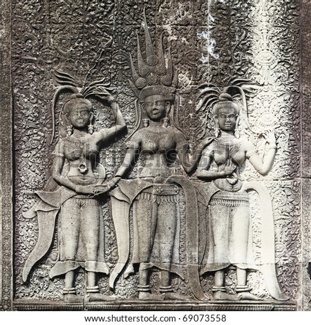 Dancing Apsaras an old Khmer art carvings on the wall in Angor Wat temple near Siem Reap town, Cambodia