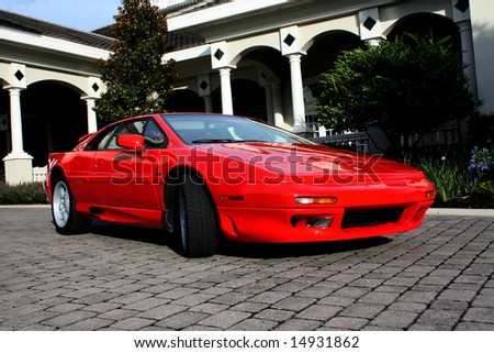 Sports car in front of mansion