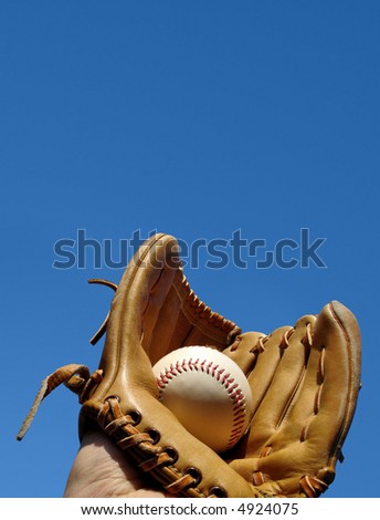 Caught baseball in glove portrait photo. Space at top for messaging.
