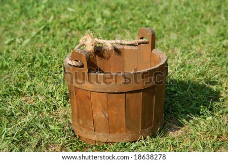 Old wooden bucket on grass
